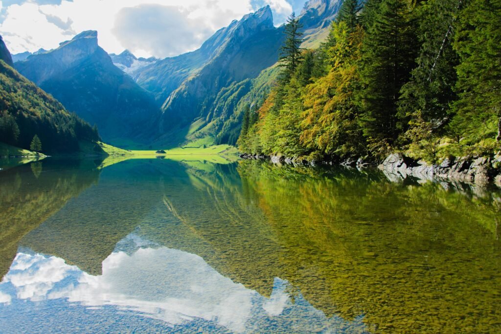 A serene mountain lake with clear reflections and lush greenery, perfect for nature enthusiasts.
